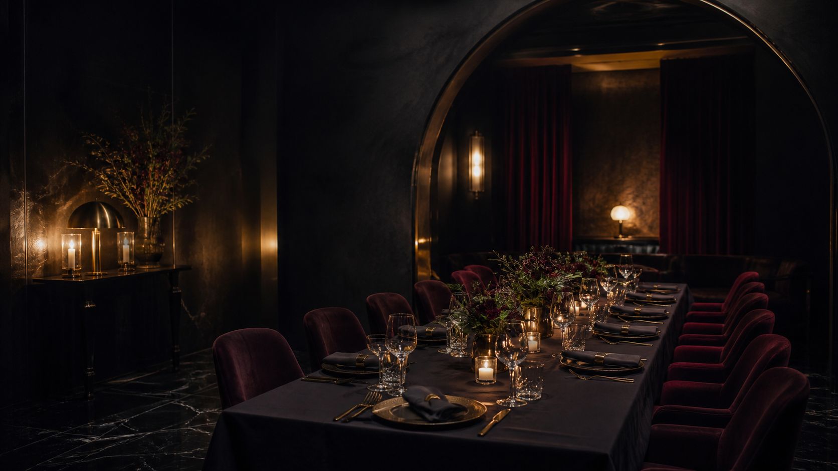 A candlelit private dining table set for a group in an imagined burgundy and obsidian room